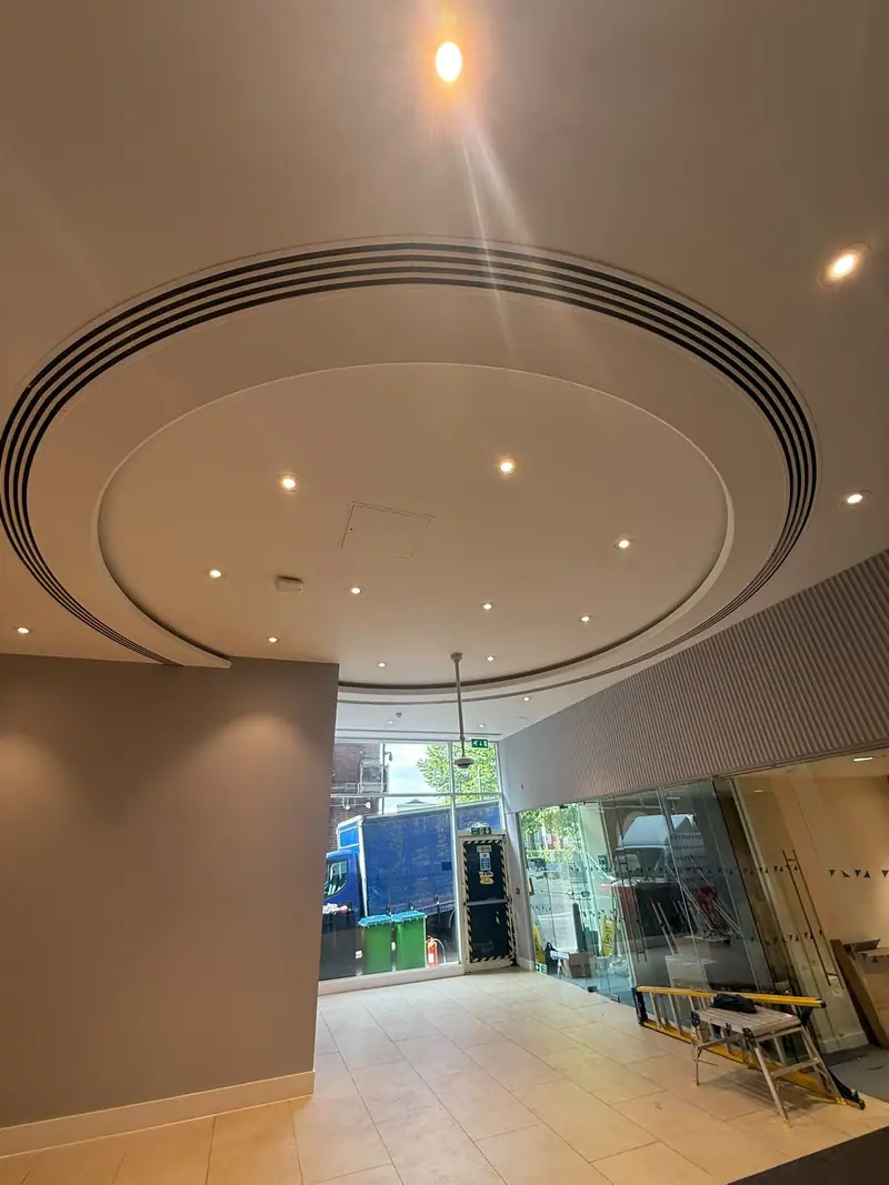 Circular slot diffuser set into a feature ceiling