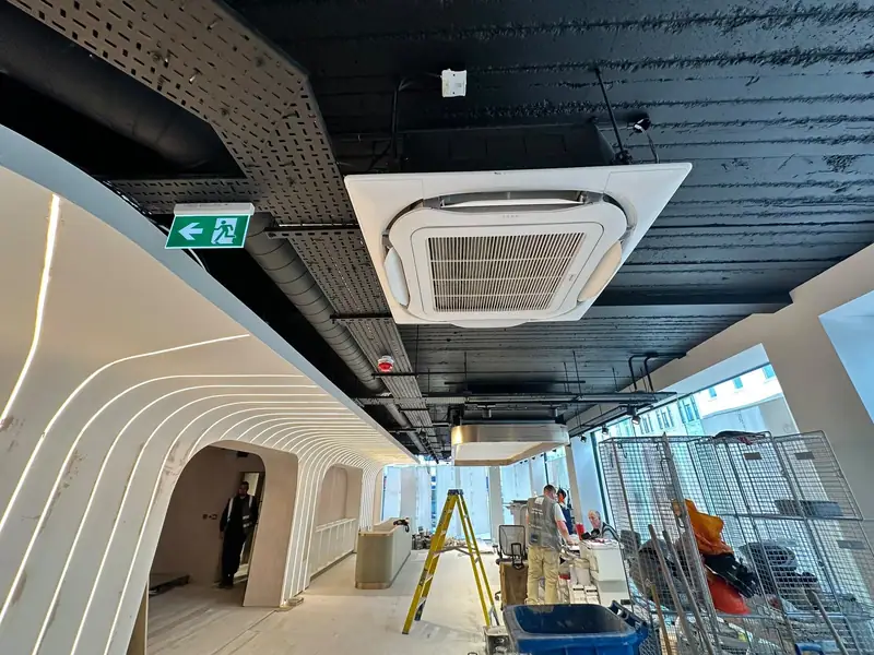 Ceiling cassette air conditioning unit in an office corridor