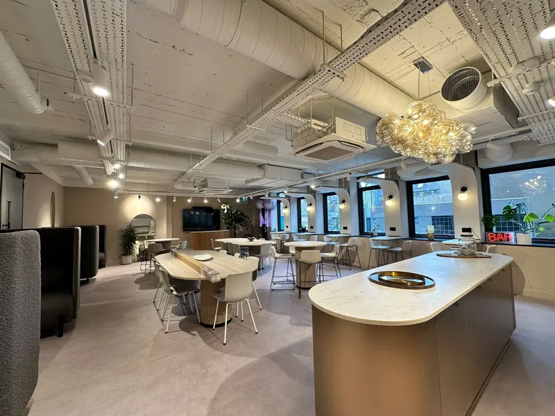 Open-plan office and kitchen with ceiling cassettes on the exposed soffit