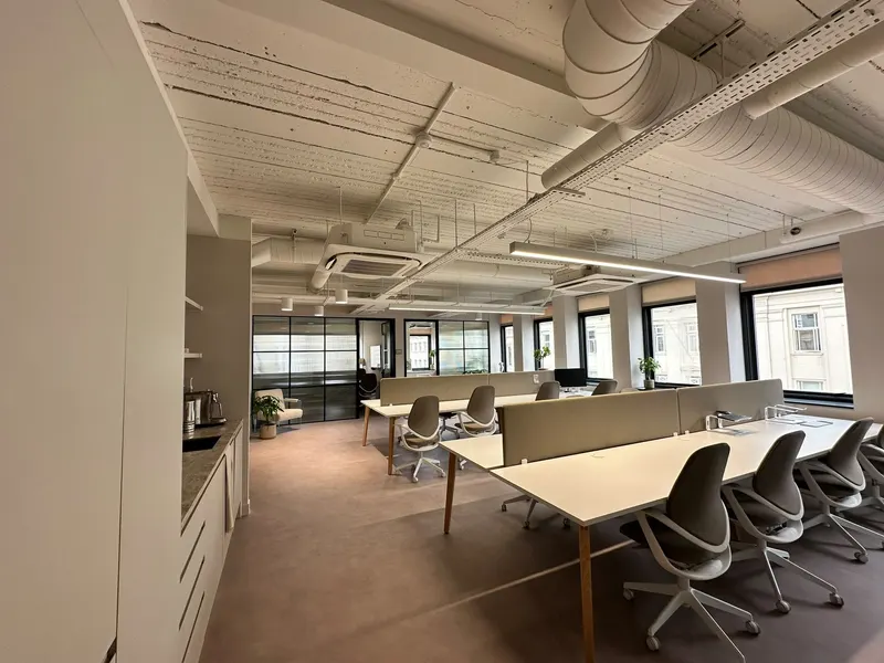 Open-plan desks beneath exposed ductwork and ceiling cassettes