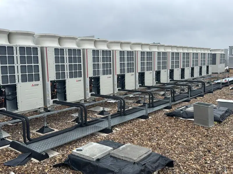 A long row of VRF condensing units on a commercial flat roof