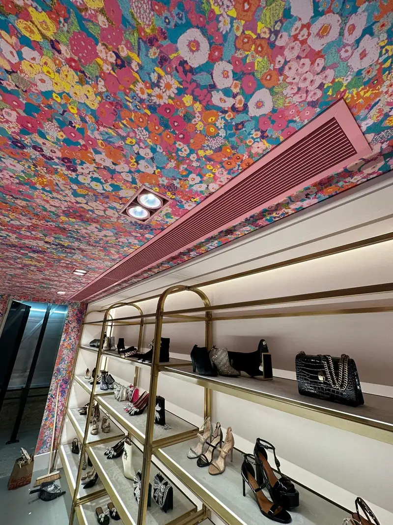 Linear grille set into the patterned ceiling above the shoe displays