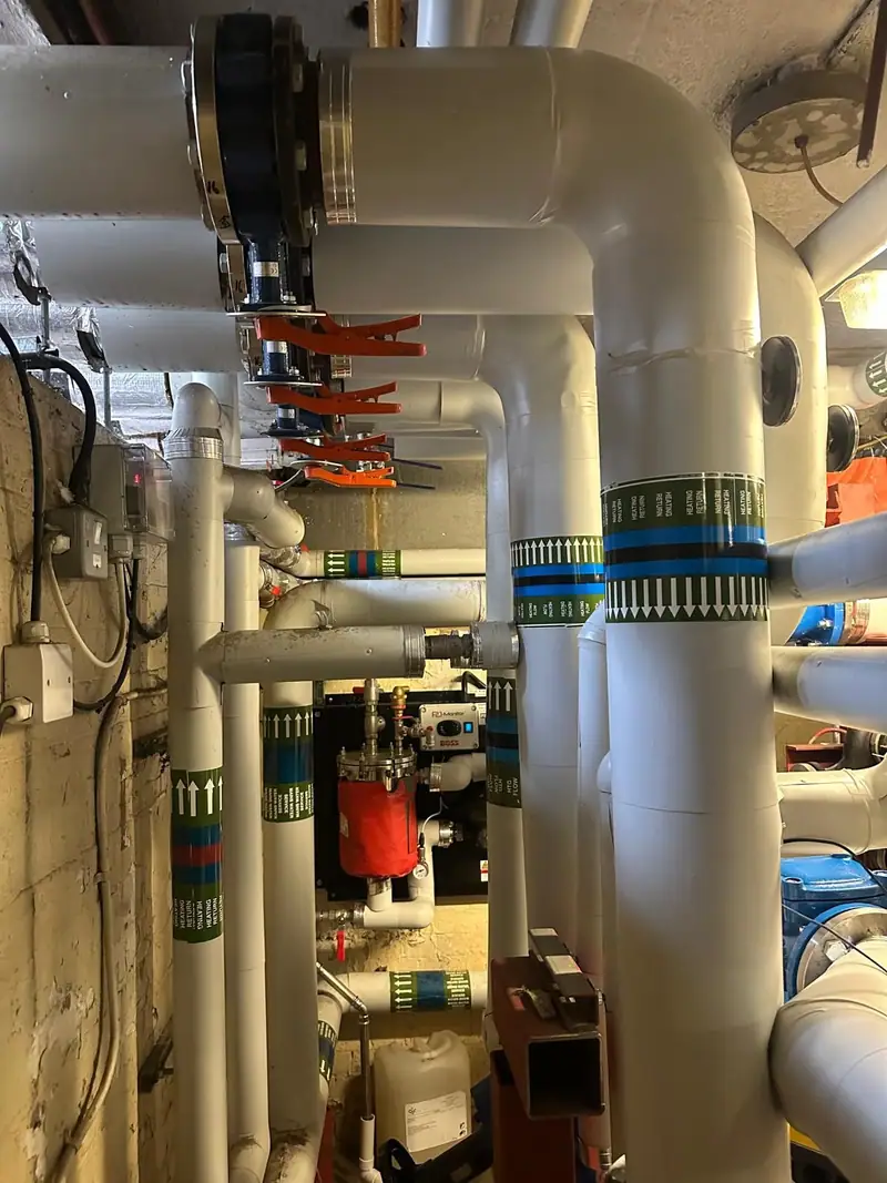 Insulated flow and return pipework rising through the plant room