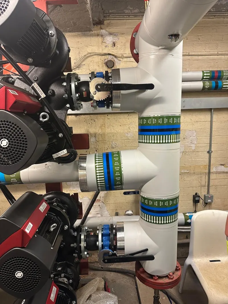Twin pumps on insulated heating pipework in the plant room