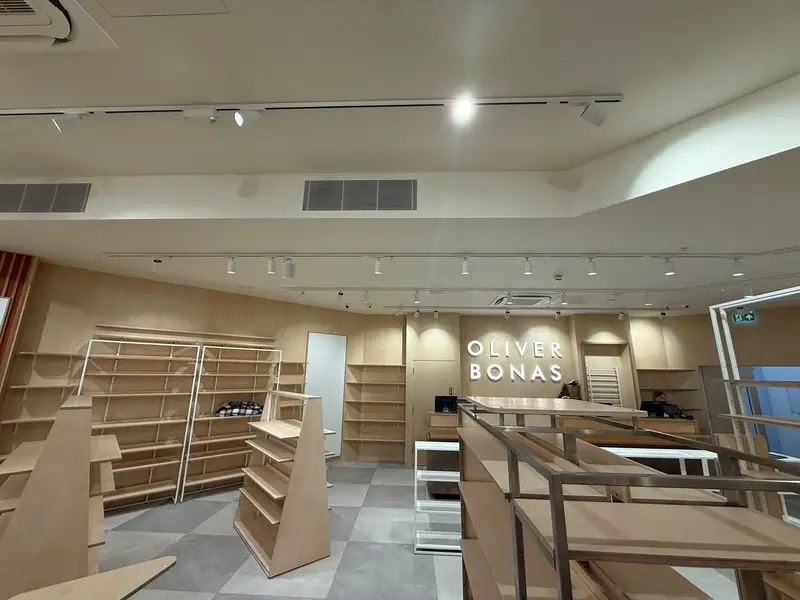 The finished Oliver Bonas store with linear grilles above the shelving